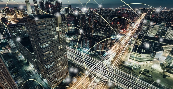 Image of glowing arcs of light bouncing around an aerial view of a city.