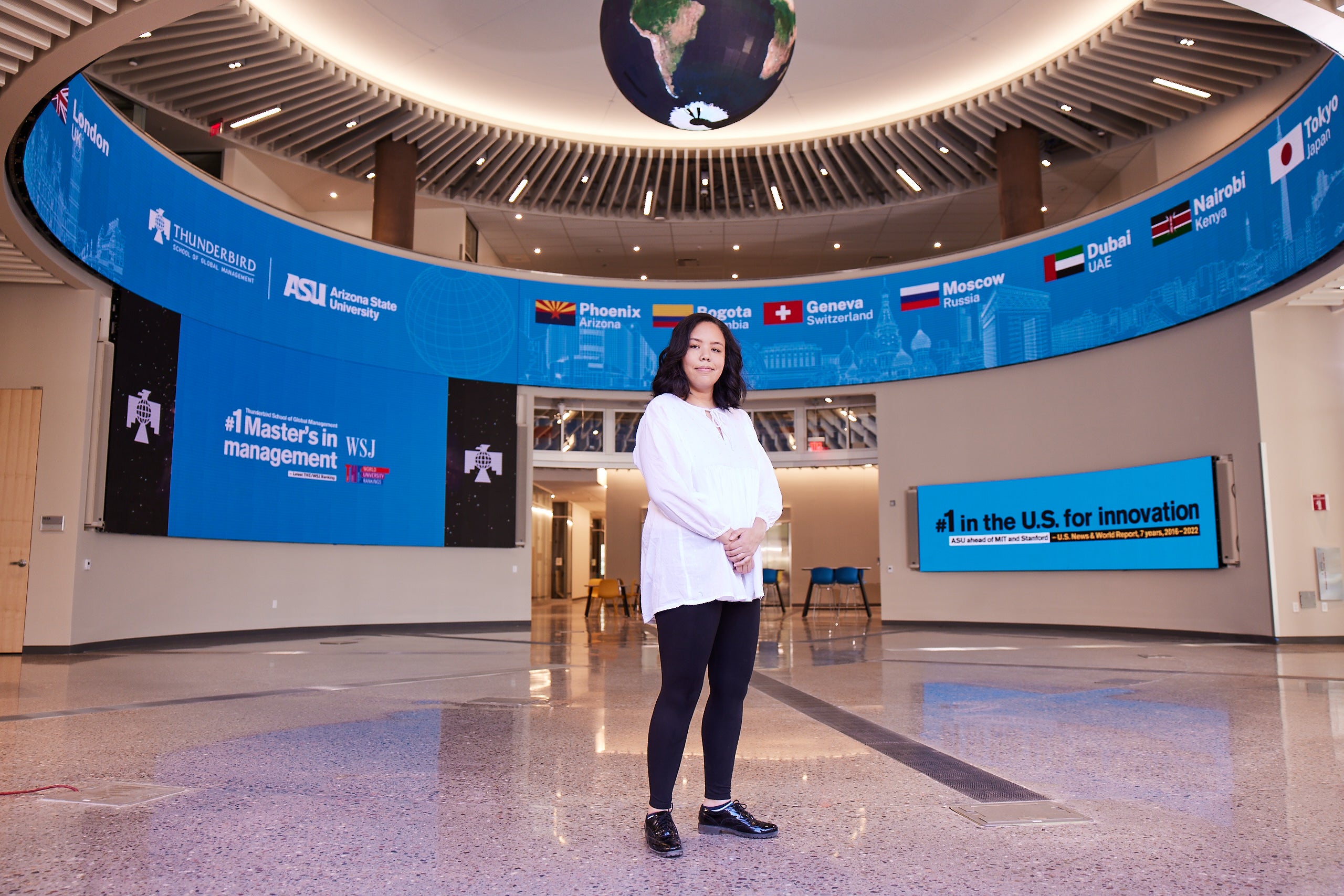 A Thunderbird student stands in the Global Forum.