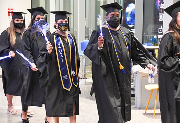 Image of Thunderbird graduates wearing their regalia and face masks at the Fall 2021 Convocation ceremony