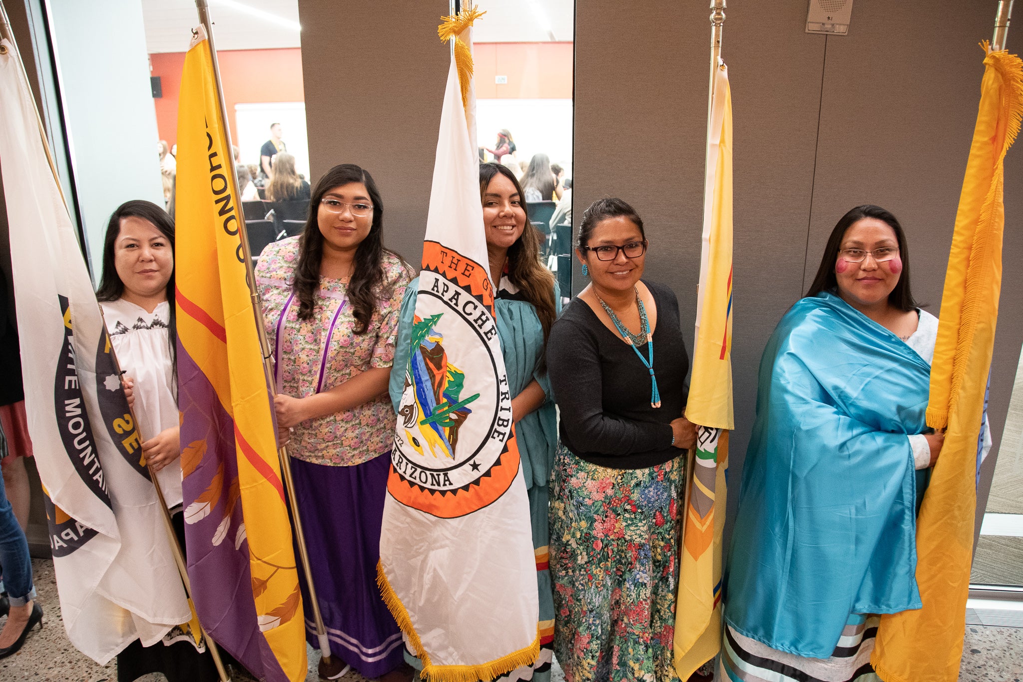 A group of Dreamcatcher participants holding the flags for their tribes.