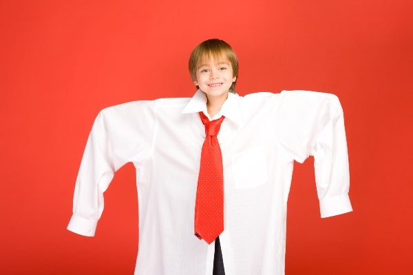 Child in an oversized adult dress shirt and oversized neckties