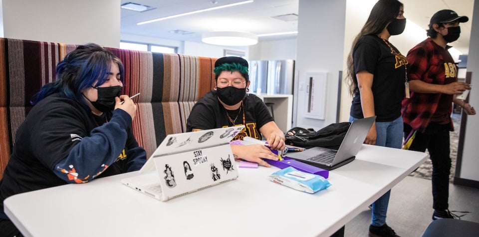 ASU Local students graphic design junior Jack Martinez, right, and psychology first year Chadney Gonzalez, left, work together on the third floor work cafe space at the California Center in downtown Los Angeles, Calif. on Tuesday afternoon Nov. 2nd, 2021. 