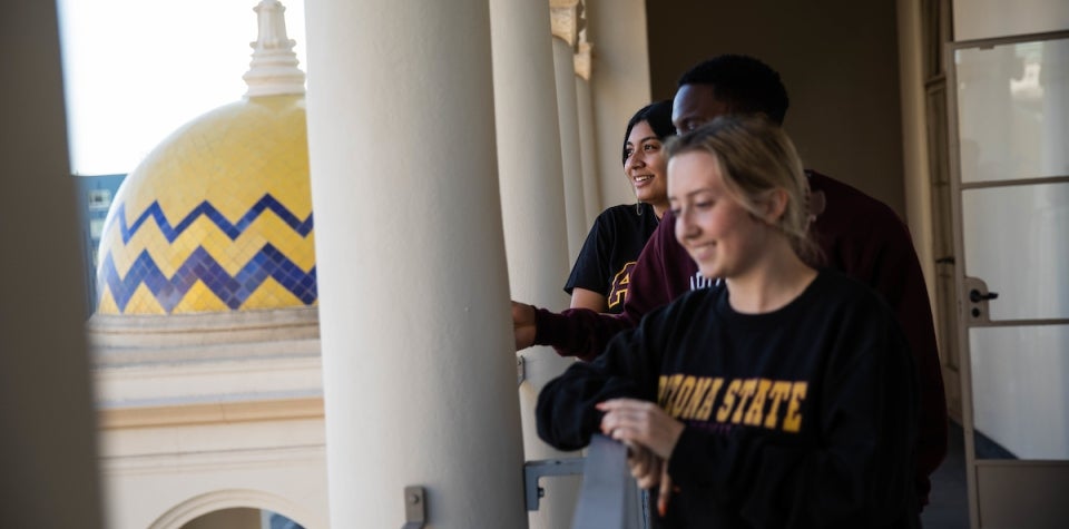 Local students psychology sophomore Julissa Rocha, community health sophomore Shawn Lofton, left, and forensic psychology junior Bridget Thornton, right, look out over the fifth floor balcony of the California Center in downtown Los Angeles, Calif. on Tuesday afternoon Nov. 2nd, 2021. 