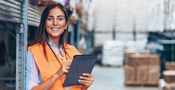 Woman holding an iPad in a warehouse