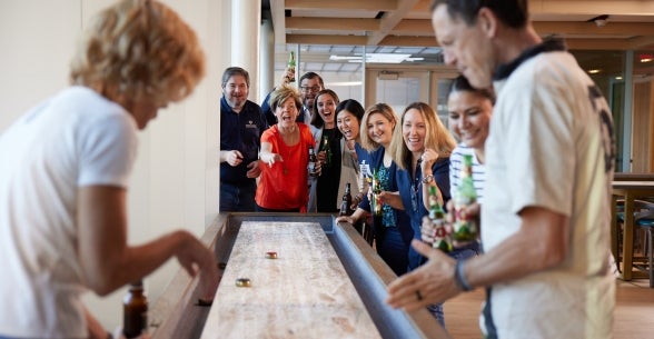 Thunderbird staff enjoy a game of shuffleboard in the Pub