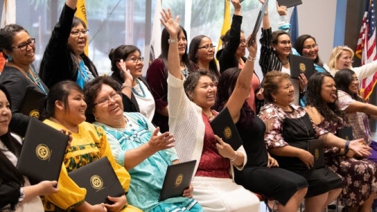 Group of DreamCatcher program participants with their degrees in hand.