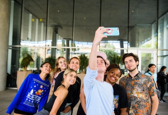 Undergraduate students take a group selfie